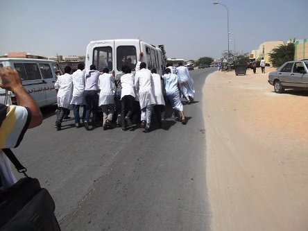 الطلاب يدفعون الباص من أجل تشغيله قبل أن ينقلهم إلى أماكن سكناهم 