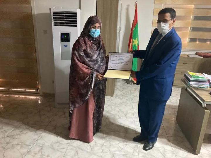 وزير الصحة محمد نذير ولد حامد يتسلم التكريم من منسقة القافلة مريم سي?